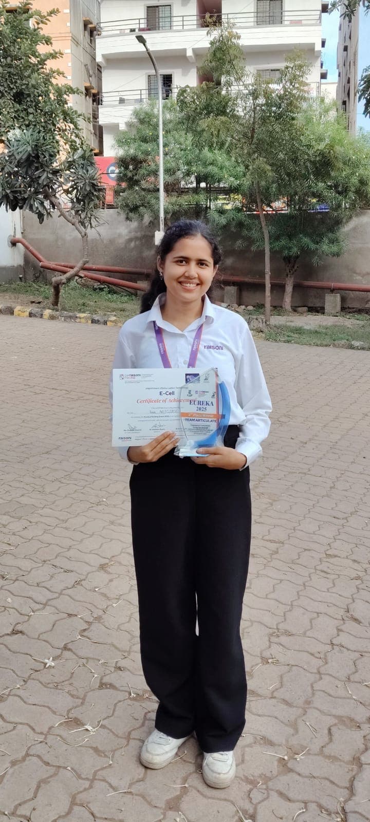 Riya with the Eureka 2025 trophy and certificate